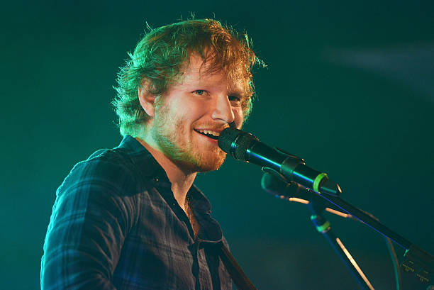 Ed Sheeran performing in a concert hall